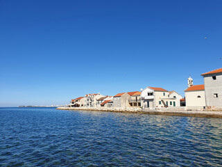 Bibinje coastal town village next to Zadar in Croatia, against clear blue sky with space for text