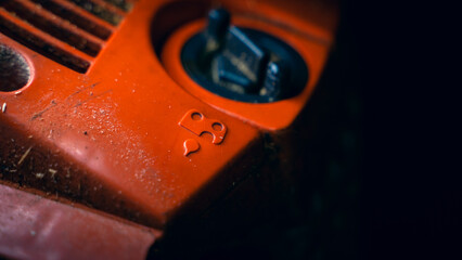 Chainsaw saw chain lubricant symbol. Oil filling container close-up