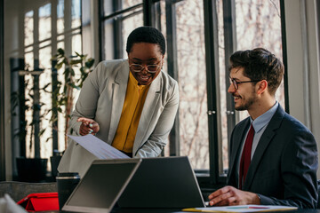 Business coworkers working together at office. Diverse people working in the bright office.