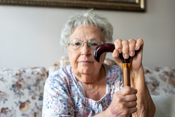 Senior woman holding a walking stick