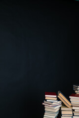 large number of books stacked on a black background in the library science knowledge
