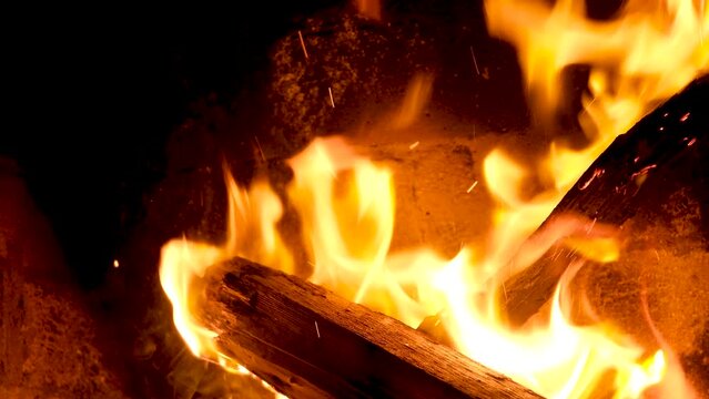 fire flames with sparks from campfire over black background. High quality 4k footage