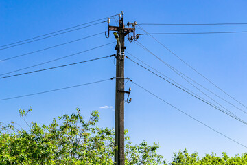 Power electric pole with line wire on colored background close up
