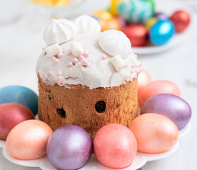 Painted Easter eggs with decorated Easter cake on white background close up with selective focus. Happy Easter concept