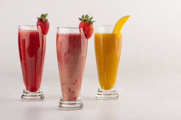 Fresh pressed juices of Mango, strawberry, and cocktail juice isolated on white background 