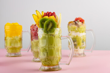 set of Fruit cocktails with fruit topping, Avocado, strawberry, Mango Cocktails with fruits and nut topping 
