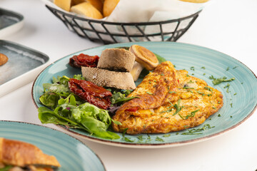 Herb omelet with mushroom, rocket leaves, and  oregano with grilled pepper and dried tomato and  Bread 