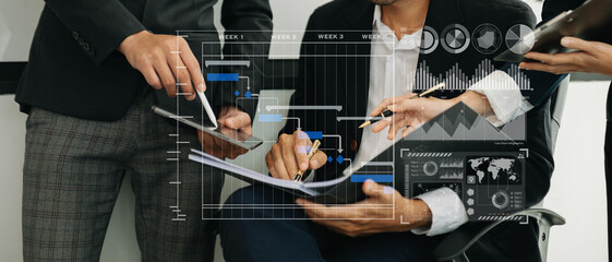 Businessman hand Project manager working and update tasks and Gantt chart scheduling virtual diagram.with smart phone, tablet and laptop in office..