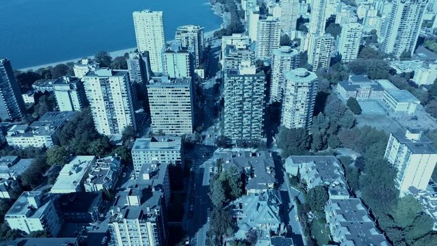 Vancouver English Bay Aerial reverse reveal flight overlooking West End residential community high rise buildings schools lush green trees, beaches, waterfront, quiet post COVID19 after math new life