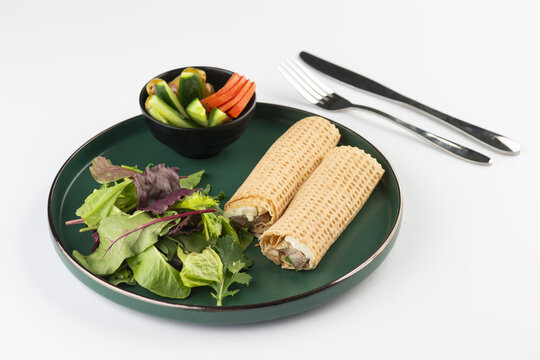 Lebanese breakfast of Labneh sandwich and Makdous Eggplant in Tannour bread wrap served with salad	
