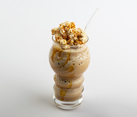Glass of coffee latte with whipped cream, caramel popcorn, Popcorn Frappe 