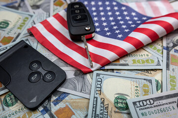 Car's keys on the dollar money and usa flag