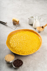 Martabak manis or terang bulan is indonesian sweet pancake, with yellow color and filled with chocolate chips, cheese, fruit jam, butter and peanut on concreate background.