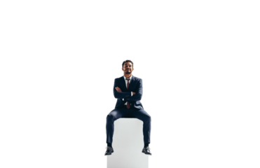 Confident young businessman sitting on top of a block on a transparent background