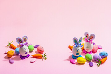 Obraz na płótnie Canvas Festive Easter composition. Traditional symbols and decor - rabbits, eggs, carrots. Pastel design