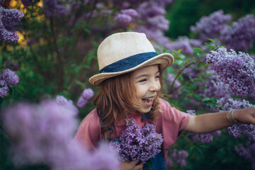Portrait of little girl with lilac, spring mood.