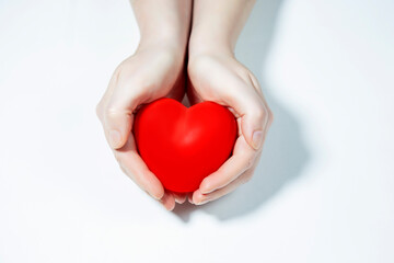 Heart in hands isolated on white background, heart health or love concept