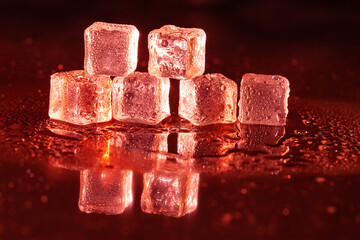 Red ice cubes on black background.