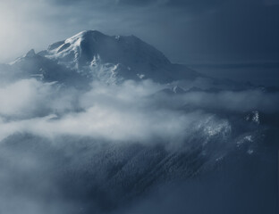 Mount Rainier surrounded by mist in winter
