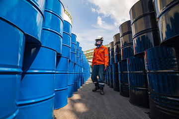 Male worker inspection record drum oil stock barrels blue horizontal or chemical put on a face half...