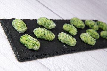 Pile of green spinach gnocchi, potato peru italian food, Homemade, High quality photo