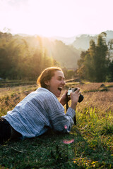 Woman taking pictures outdoor with a digital camera. Travel, vacations, professional freelance work and active lifestyle concept.