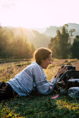 Woman taking pictures outdoor with a digital camera. Travel, vacations, professional freelance work and active lifestyle concept.