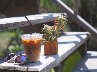 glass of iced coffee and sunglasses on table