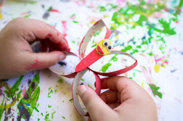Child making a butterfly with recycled materials and EVA foam