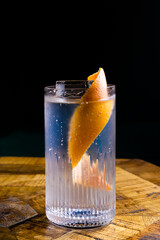 Stemmed cocktail glass with alcoholic drink, close-up isolated on black. Template design