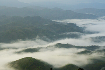 Landscape Green nature fog and misty cover around mountain valley seen from Skywalk Aiyerweng Famous landmark in Betong Yala southern thailand - in the morning - Travel and Sighseeing South east Asia 