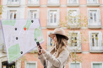 Woman navigating location with smart phone in front of building