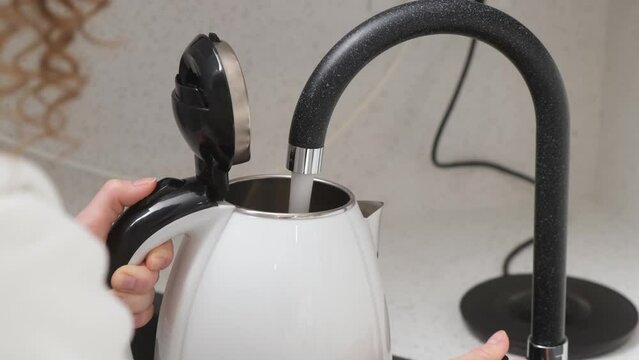 The modern style kettle is filled with purified and pure water.