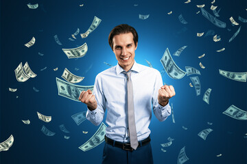 Obraz na płótnie Canvas Finance freedom, money, wealth and success concept with powerful and happy man on dark blue background under dollar banknotes rain