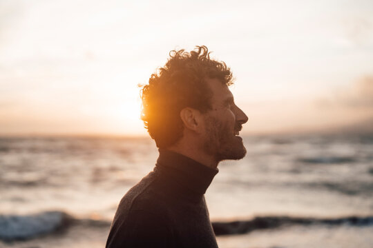 Back Lit Man In Front Of Sea At Sunset