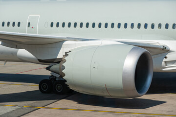 Airplane on runway, turbine engine close-up