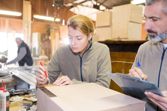 woman as apprentice of craftsman taking a test