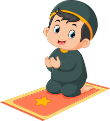 a cute Muslim boy is praying on his prayer mat