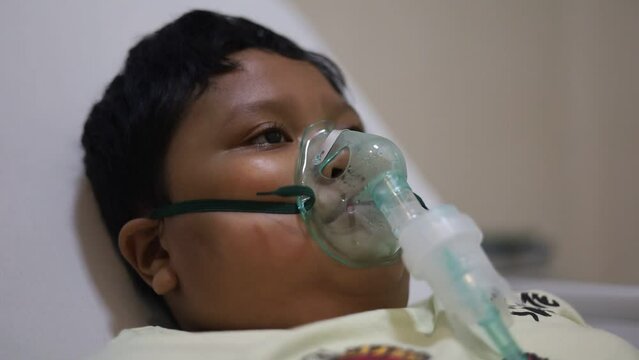 Children patients on bed with oxygen mask in hospital