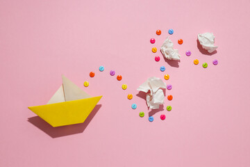 Concept of difficulties on the way to the goal with paper boat