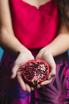 Hands Of Woman Holding Pomegranate Fruit