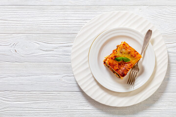 portion of Lasagna on white plate, top view