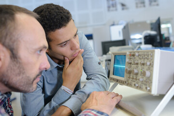 Fototapeta na wymiar two men looking at radio frequency screen