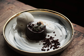 Closeup dessert of Chocolate pudding with ice cream in white plate - sweet and delicious - image from Nan Thailand 