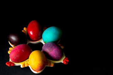 Colored easter eggs on a black background