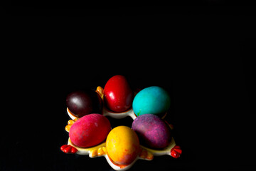 Colored easter eggs on a black background