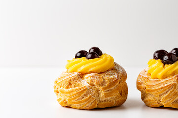 Italian dessert Zeppole di San Giuseppe, zeppola - baked puffs made from choux pastry, filled and...