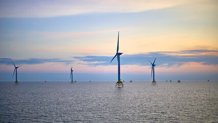 Electricity production by offshore wind turbine farm in the sea.