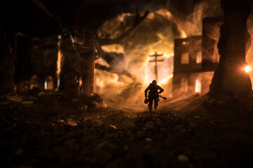 Obraz premium War Concept. Military silhouettes fighting scene on war fog sky background, World War Soldiers Silhouette Below Cloudy Skyline At night. Battle in ruined city.