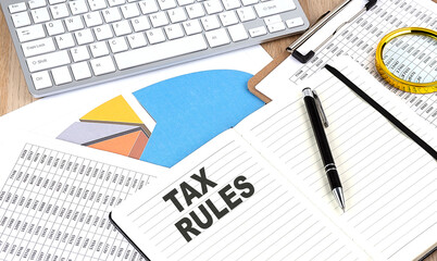 TAX RULES text on a paper on chart background